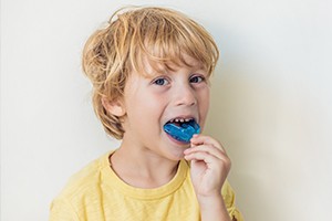 Child placing mouthguard