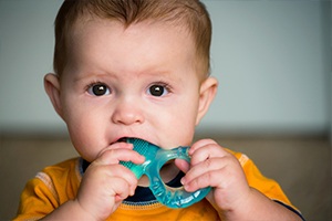 Child chewing on teething ring