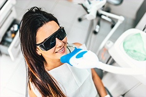 Woman receiving teeth whitening treatment