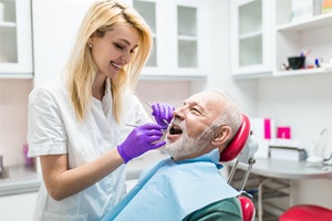 An older man in the dentist chair having his teeth checked