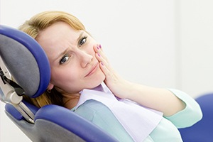 Woman holding jaw in pain