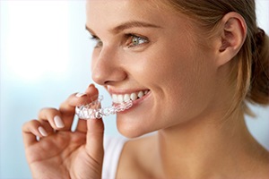 Woman placing Invisalign tray