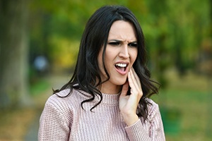 Woman in pain holding jaw