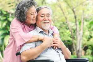 older couple smiling hugging